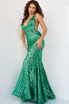 A woman poses against a white background wearing the floor-length, sleeveless Emerald Green Jovani Sequin Prom Dress 24097, featuring geometric patterns and side cutouts.