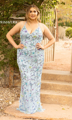 A woman stands outdoors by a gate, wearing the Plus-Size Sequin Butterfly Long Prom Dress 14003—a light blue gown with sequins, butterfly accents, and spaghetti straps.