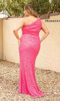 A woman stands on gravel outdoors, facing away with one hand on her hip, wearing the One-Shoulder Long Sequin Plus-Size Prom Dress in bright pink.