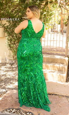 A woman faces away outdoors near a gate, surrounded by greenery, wearing the Sleek Plus-Size Sequin-Print Long Prom Dress 14008—a sleeveless, floor-length green gown with a deep V back.