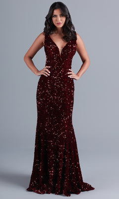 Woman wearing the PromGirl Deep V-Neck Red Long Sequin Prom Dress, a sleeveless, floor-length gown with a sparkly finish, shown against a plain gray background.