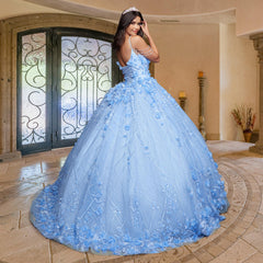A young woman stands indoors, facing backward and looking over her shoulder, wearing the Quinceañera Sample Dress QF105—a light blue cold-shoulder gown with floral details and a tiara.