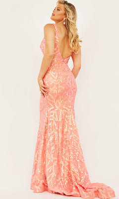 Woman wearing a floor-length, sleeveless Jovani Plus-Size Sequin Prom Dress with train, featuring gold sequin details and a low back, standing against a plain background.