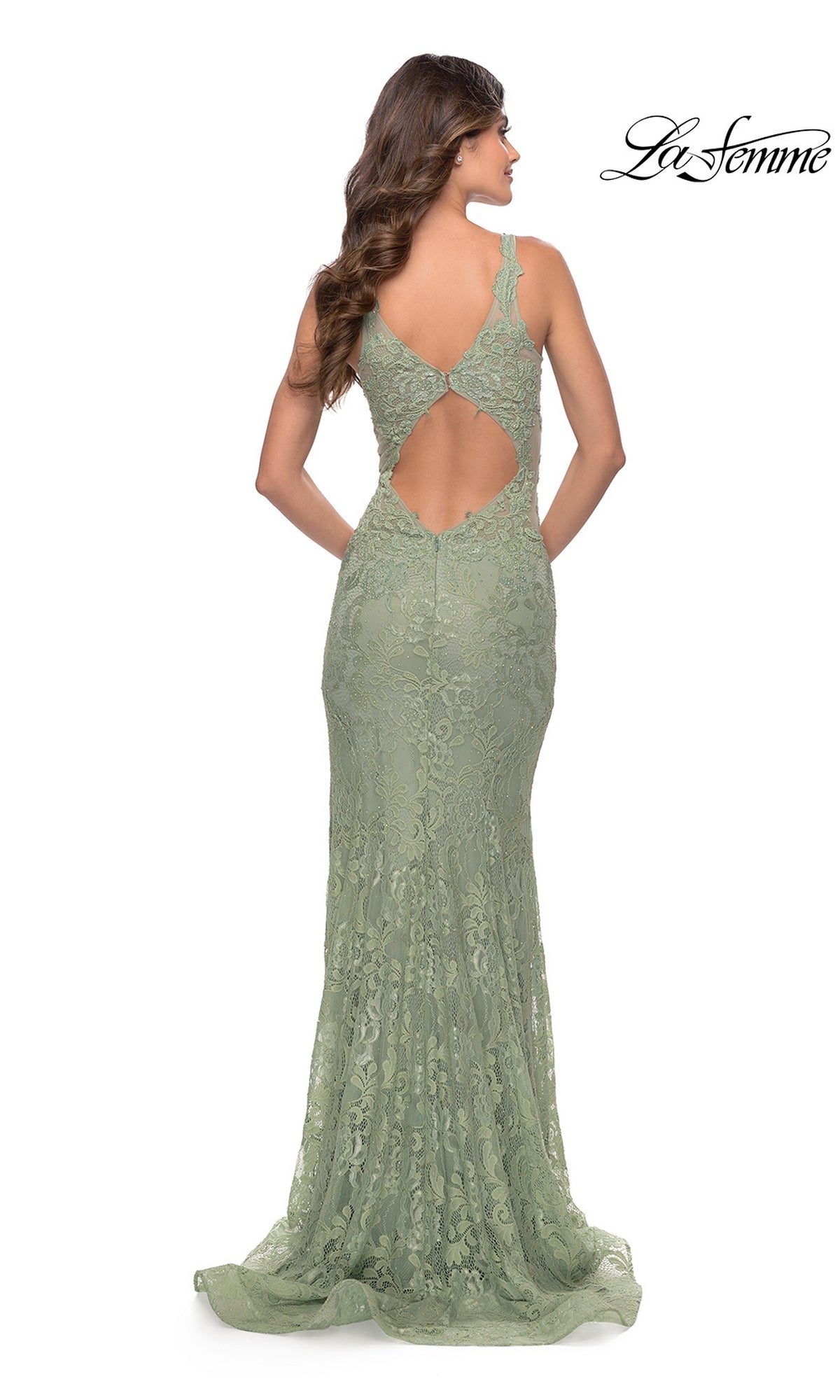 A woman stands facing away, wearing the La Femme Long Lace Prom Dress with Plunging V-Neck in light green, featuring floral lace and a keyhole back. The La Femme logo appears in the top right corner.