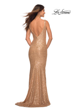 A woman stands facing away in a La Femme Floor-Length V-Neck Sequin Prom Dress, featuring gold sequins and a deep V-back. The "La Femme" logo appears in the top right corner.