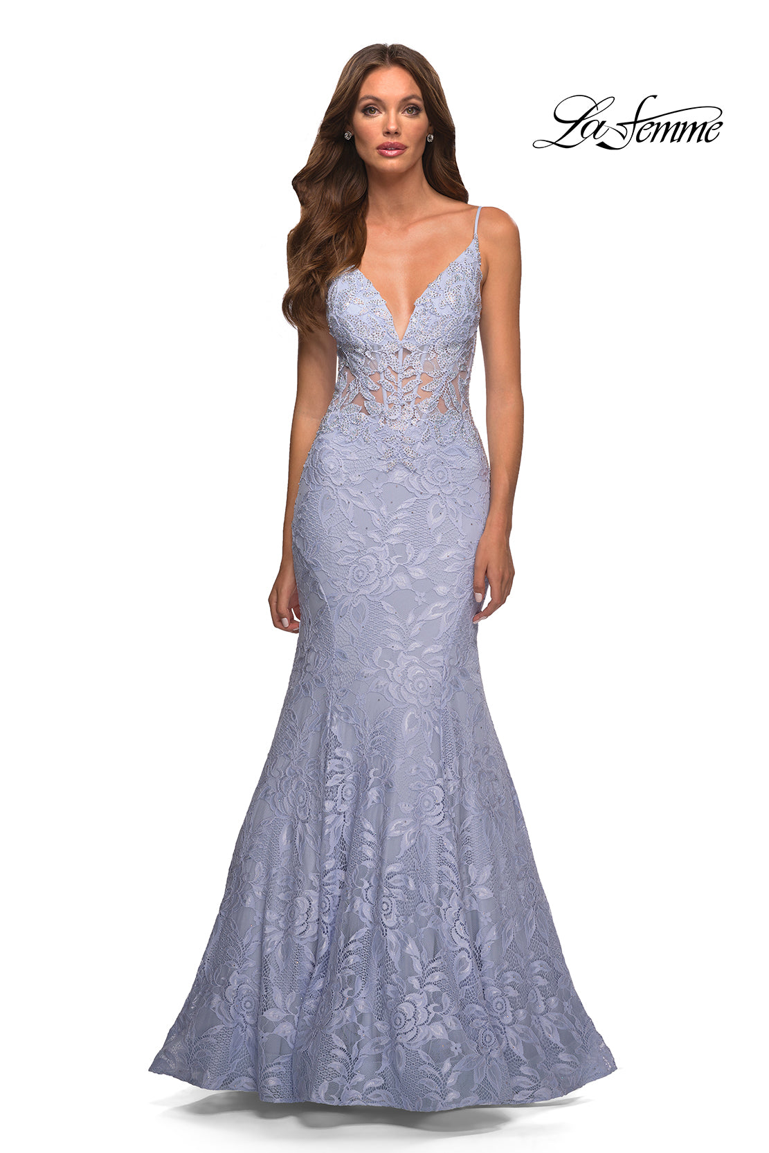 A woman wears the La Femme Lace Sheer-Waist Long Mermaid Prom Dress—a lavender lace gown with a plunging neckline and thin straps—standing against a plain white background. The La Femme logo is in the top right corner.
