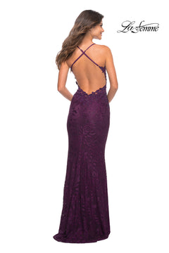 Woman wearing a floor-length, purple La Femme Long Prom Dress with Sheer Beaded Sides and crisscross straps, featuring a low open back, standing and facing away from the camera.
