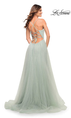 Woman wearing La Femme Long Beaded Tulle Ball Gown for Prom in light green with sparkly beads, a criss-cross lace-up open back, standing and smiling.
