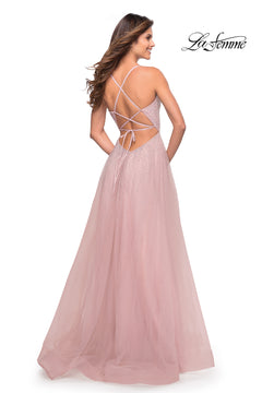 Woman in a Corset-Back Long La Femme A-Line Prom Dress with light pink tulle skirt, sparkly embellishments, and crisscross lace-up open back, standing and facing away for an elegant look.