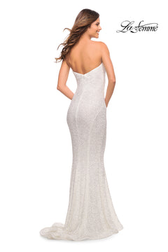 A woman stands with her back to the camera, wearing the La Femme Strapless Long Sequin Formal Dress—fitted, floor-length, white, with a slight train. The "La Femme" logo is displayed in the top right corner.