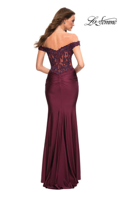 A woman models the Lace-Bodice La Femme Off-the-Shoulder Prom Dress in burgundy, featuring a sheer lace bodice and a floor-length skirt, elegantly displayed from the back.