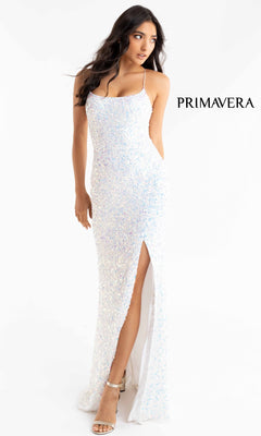 A woman models the Strappy-Back Pastel Long Sequin Prom Dress 3290 with a thigh-high slit and spaghetti straps, against a white backdrop. The "PRIMAVERA" logo is displayed on the right, emphasizing this elegant formal dress.