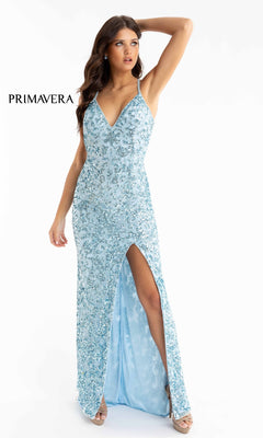 A woman poses against a white background in the Pastel Sequin-Pattern Long Prom Dress 3295, a light blue formal gown with sequins and a thigh-high slit. The word "PRIMAVERA" appears beside her.
