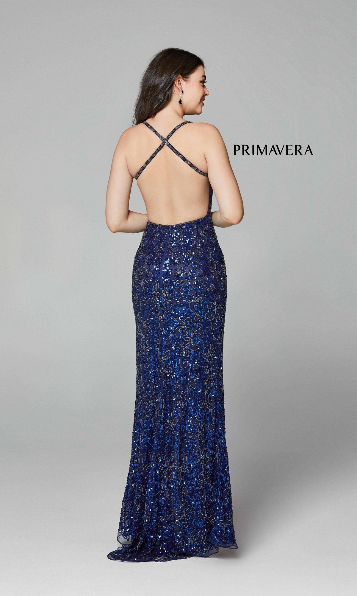 A woman faces away in the Dark Sequin-Pattern Long Prom Dress 3295D, featuring a floor-length silhouette and crisscross open back. The word 