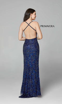 A woman faces away in the Dark Sequin-Pattern Long Prom Dress 3295D, featuring a floor-length silhouette and crisscross open back. The word "PRIMAVERA" appears on a plain light gray background.
