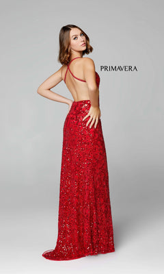 A woman poses with one hand on her hip in the Dark Sequin-Pattern Long Prom Dress 3295D, a backless, floor-length gown, against a plain light background. The word "Primavera" appears beside her.