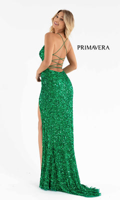 Woman in the Bright Wrap-Style Long Sequin Prom Dress 3791B, featuring sparkling green sequins, a strappy back, and high slit. "PRIMAVERA" appears in the background—perfect inspiration for your next formal event.