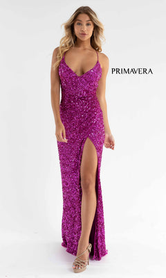 A woman models the Bright Wrap-Style Long Sequin Prom Dress 3791B in magenta, featuring a sleeveless design and thigh-high slit, with strappy heels against a white background. "PRIMAVERA" appears beside her.