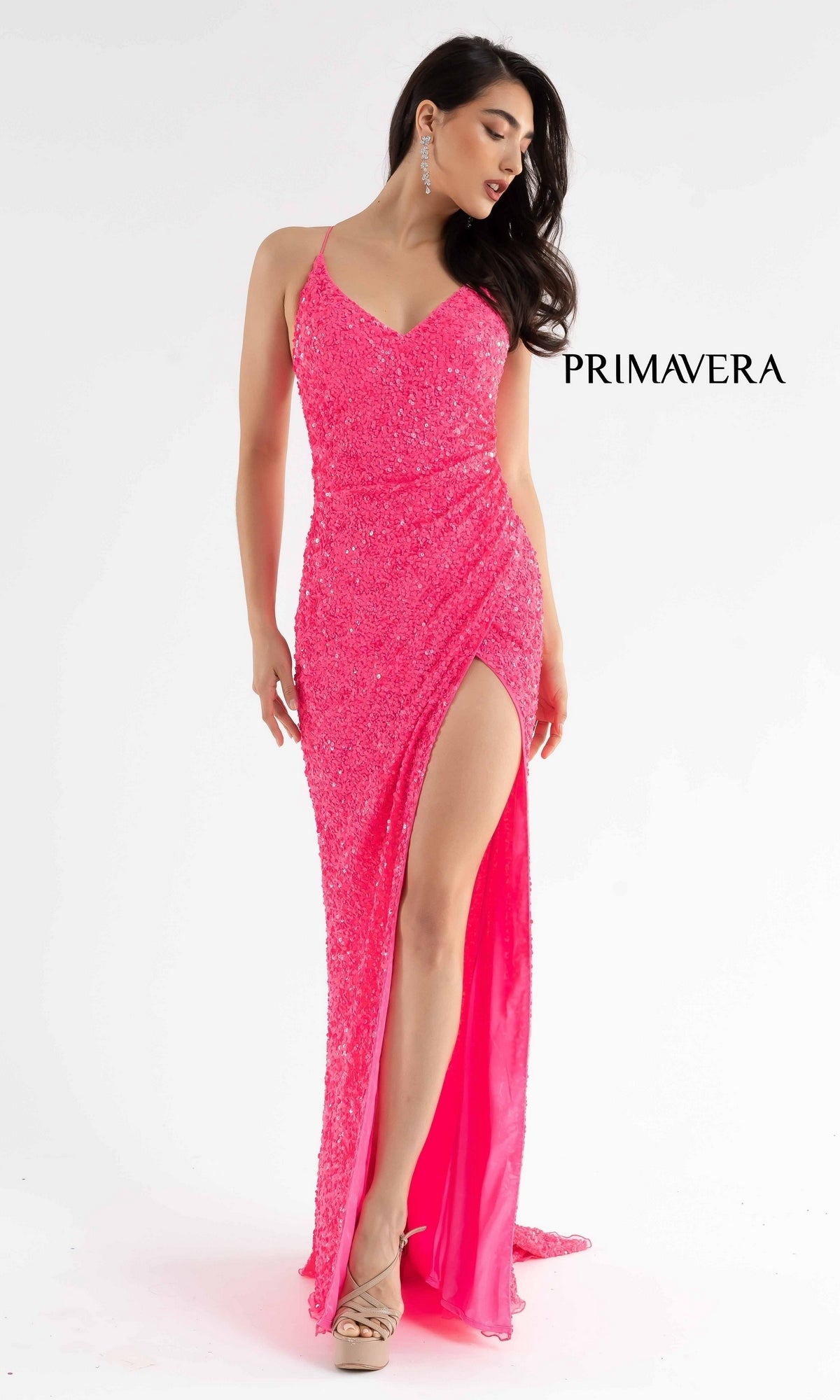 A woman poses against a white background in the Bright Wrap-Style Long Sequin Prom Dress 3791B—a vivid pink, sparkly gown with thin straps and a high skirt slit—shining beside the word 