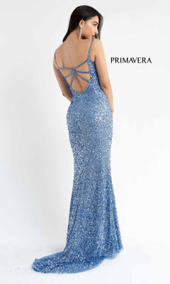 A woman in the Strappy Open-Back Long Sequin Prom Dress 3792 stands against a white background. The sparkling blue v-neck gown features a strappy open back, with "PRIMAVERA" displayed beside her.