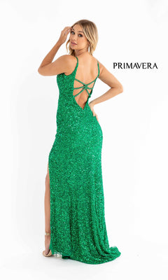 Woman in the Bright Sequin-Print Long Prom Dress 3792B: a sparkly green gown with crisscross back straps, high slit, and open back. The PRIMAVERA logo appears on the right—ideal for special occasions or as a formal dress.