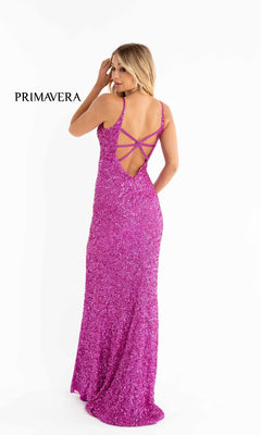 A woman faces away against a white background, wearing the Bright Sequin-Print Long Prom Dress 3792B— a floor-length, glittery purple gown with thin straps and an open strappy back. The word "PRIMAVERA" is shown to the left.