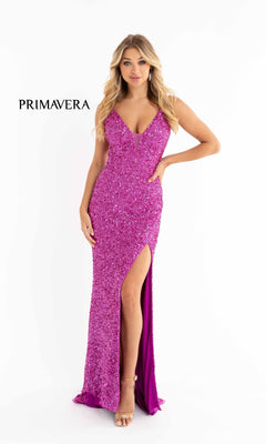 A woman models the Bright Sequin-Print Long Prom Dress 3792B, featuring spaghetti straps and a thigh-high slit in fuchsia sequins, standing against a white background. "PRIMAVERA" is displayed on the left.