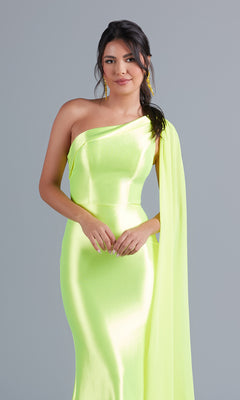 A woman models the PromGirl One-Shoulder-Sash Neon Long Prom Dress, a shiny neon yellow gown with a draped sleeve, against a plain gray background.