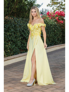 A woman stands on a paved path outdoors, wearing the Long Corset-Back Prom Dress with Beaded Bodice. Shrubs and flowering plants are in the background.