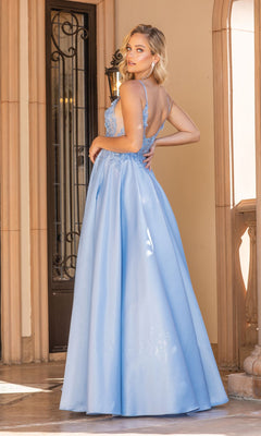 A woman in the A-Line Long Prom Ball Gown: Dancing Queen 4326, a light blue floor-length dress with a low back, stands near a doorway looking over her shoulder—a true Dancing Queen moment.