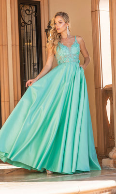 A woman stands on stone steps near a decorative doorway, wearing the Dancing Queen 4326 A-Line Long Prom Ball Gown with a sleeveless aqua blue lace bodice and flowing satin skirt.
