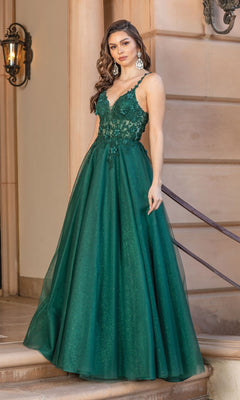 A woman stands on stone steps near a beige wall, wearing the Dancing Queen 4328 Long Glitter Prom Dress—sleeveless, deep green with a floral lace bodice and full skirt.