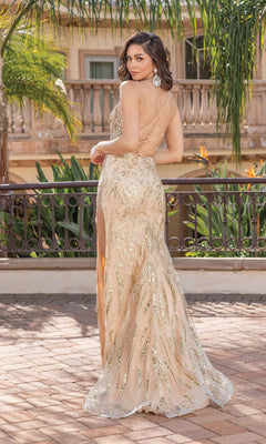 A woman wearing the Glitter Tight Formal Dress With Sheer Bodice 4334, a champagne sequin gown with a low back, cross-strap detail, and side slit, stands on a patio outdoors, facing away and glancing over her shoulder.
