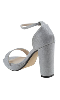The Mia Silver High Heel Prom Shoes 4580 feature a thick block heel and ankle strap, showcased from a rear-side angle.