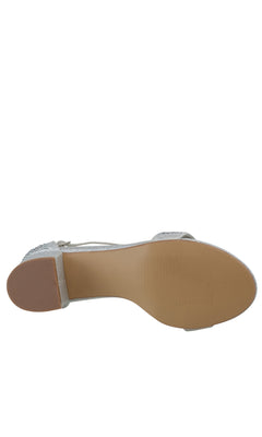 The image shows the bottom view of the Astra Silver Low Block-Heel Prom Shoes 4601, featuring a tan sole, low block heel, and elegant rhinestone straps.