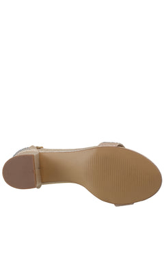 A close-up of the sole on Astra Champagne Low Block-Heel Prom Shoes 4602 shows a textured grip and heel, offering stability similar to that of classic beige flat sandals.