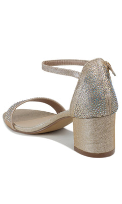 The Astra Champagne Low Block-Heel Prom Shoes 4602 feature a gold glittery finish, rhinestone details, an ankle strap, and open toe; seen from the back, they're a stunning choice for prom.
