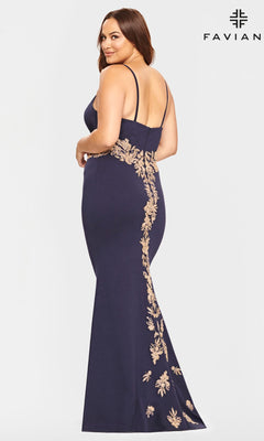 A woman in the Navy and Gold Plus-Size Faviana Prom Dress 9540 faces away, glancing back. The gown features thin straps, gold floral embroidery, and a flattering mermaid silhouette for an elegant prom look.