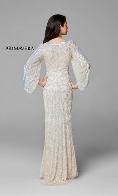 A woman faces away from the camera in a Long Bell Sleeve Beaded Evening Gown 9713 with a fitted waist, floor-length silhouette, and sheer beadwork. "Primavera" appears to the left against a plain gray background.