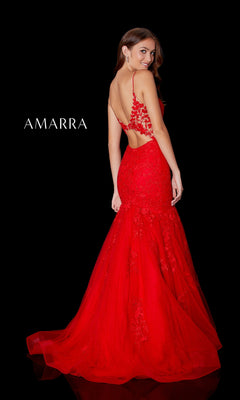 A woman models the Amarra 87226 Long Lace Mermaid Prom Dress—an elegant red, floor-length gown with thin straps and a low back—posing gracefully before a black background featuring "AMARRA" on the left.