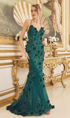 A woman stands in a lavishly decorated room wearing a Backless Emerald Green Prom Dress with 3-D Flowers, surrounded by gold accents and ornate furniture.