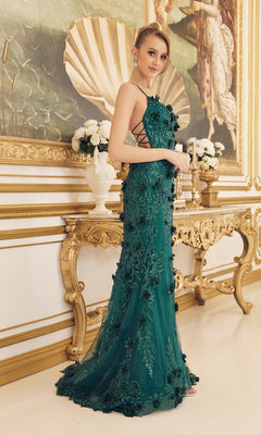 A woman wearing a Backless Emerald Green Prom Dress with 3-D Flowers stands in an ornate room featuring gold accents and a large classical painting on the wall.