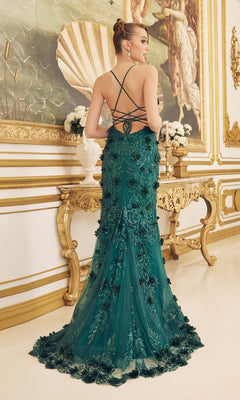 Wearing the Backless Emerald Green Prom Dress with 3-D Flowers, a woman stands in an ornate room decorated with gold accents and classical artwork.