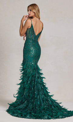 A woman faces away in the Open-Back Shimmer Prom Dress with Feather Skirt, featuring a low back, thin straps, sparkling embellishments, and a sheer corset with a deep green shimmer and feathered skirt.