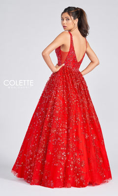 A woman in the Colette Designer Prom Sequin & Glitter Ball Gown, sleeveless and floor-length, with gold embroidery and a deep V-back, stands against a plain background looking over her shoulder.
