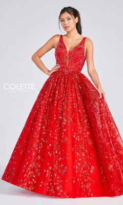 A woman poses in the Colette Designer Prom Sequin & Glitter Ball Gown, a sleeveless deep V-neck red ball gown with gold and red embroidery, radiating designer elegance against a plain light background.