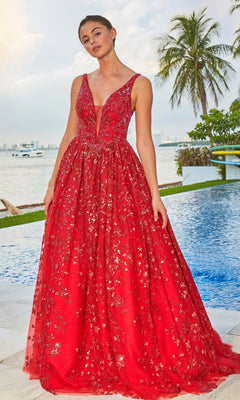 A woman in the Colette Designer Prom Sequin & Glitter Ball Gown, a sleeveless, floor-length dress with floral details, stands poolside with palm trees and shimmering water in the background.