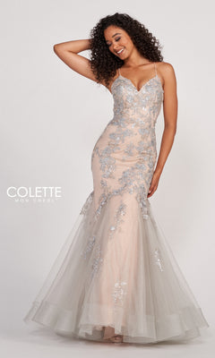 A woman poses with one hand on her head in the Colette Silver Lace Long Nude Mermaid Prom Dress, featuring a fitted, floor-length silhouette with floral lace details and spaghetti straps.