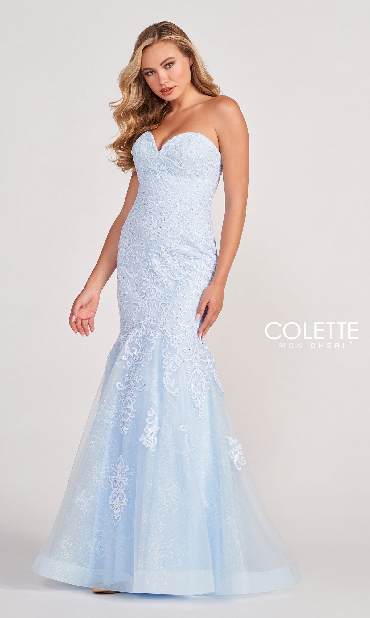 A woman wearing the Colette Pastel Strapless Lace Mermaid Prom Dress with a fitted bodice and flared skirt; 