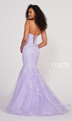 A woman with curly hair models the Colette Pastel Strapless Lace Mermaid Prom Dress in lavender, featuring delicate lace details and a stunning corset back, set against a plain background.